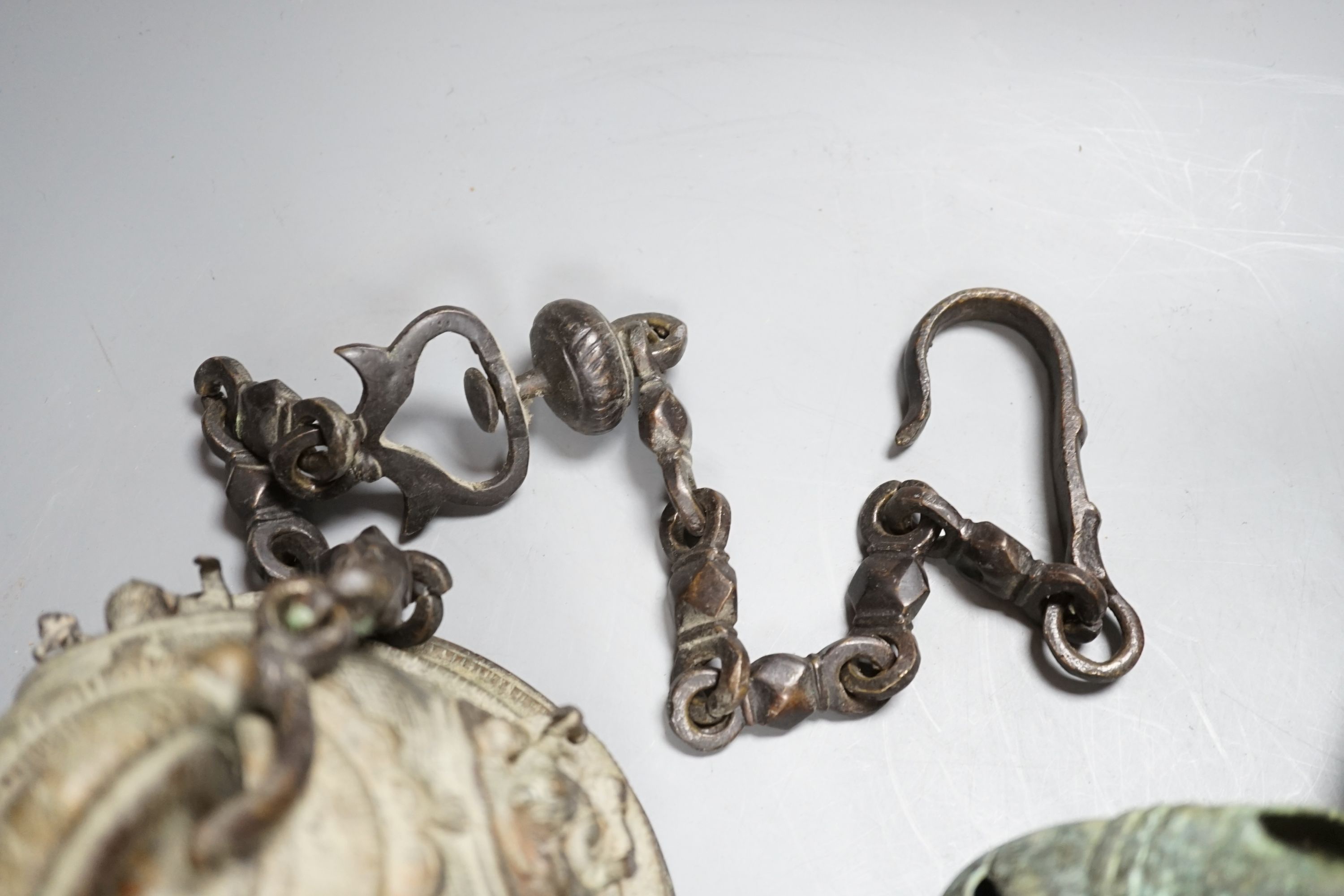 A large, archaic tic bronze figure, 76cm, and a bronze bell on chain